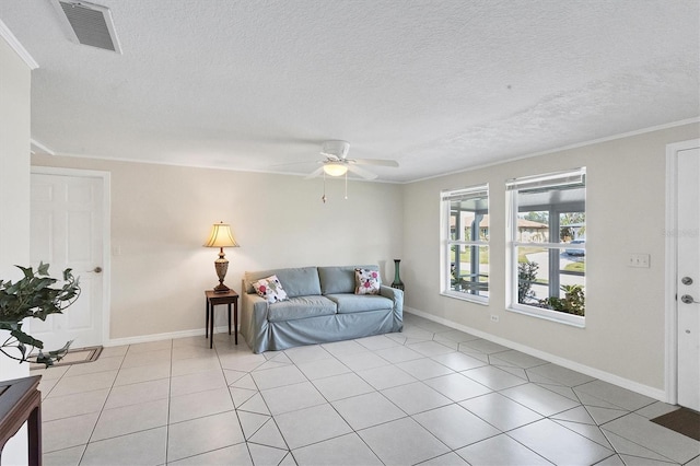 living room featuring a textured ceiling, light tile patterned flooring, visible vents, and baseboards