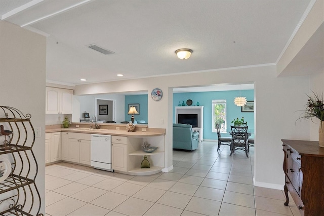 kitchen featuring a sink, visible vents, dishwasher, and ornamental molding