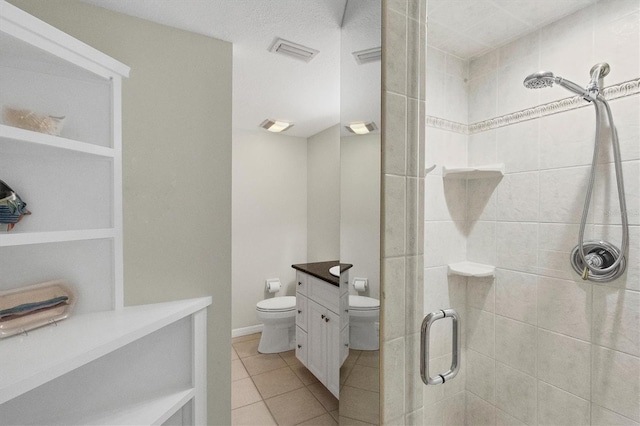 bathroom featuring a stall shower, visible vents, toilet, tile patterned floors, and vanity