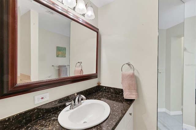 bathroom with visible vents, vanity, and tile patterned floors