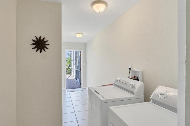 laundry room with laundry area, light tile patterned flooring, and independent washer and dryer