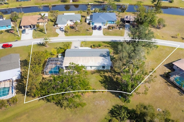 drone / aerial view with a residential view and a water view