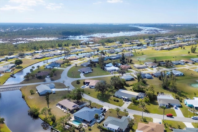 drone / aerial view with a water view and a residential view