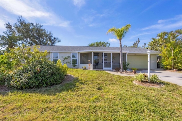 ranch-style home with stucco siding, a sunroom, a garage, driveway, and a front lawn