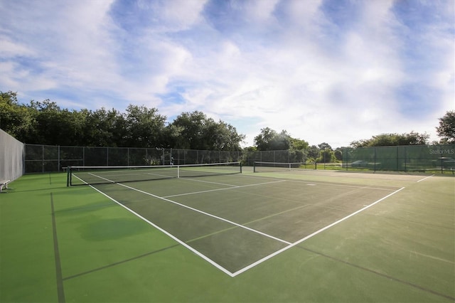 view of tennis court featuring fence