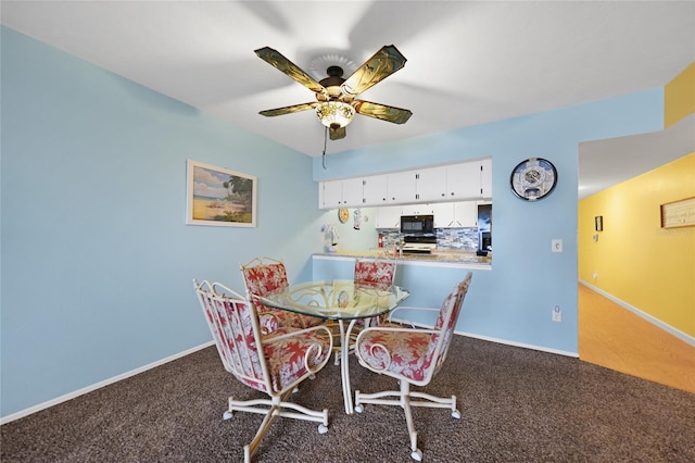 dining space featuring ceiling fan and carpet