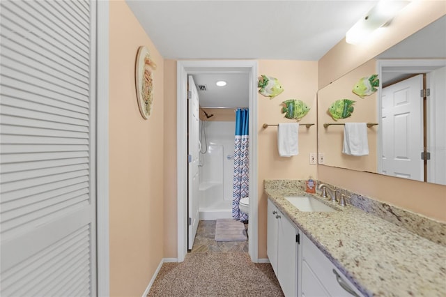 bathroom featuring vanity, toilet, and curtained shower