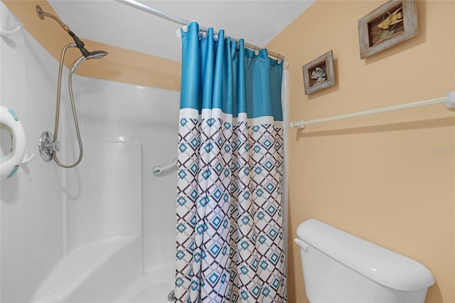 bathroom featuring walk in shower and toilet