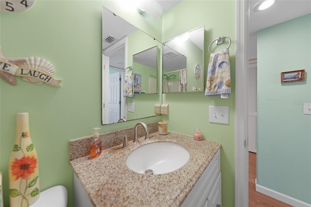 bathroom featuring vanity and hardwood / wood-style floors