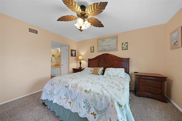 bedroom featuring carpet floors, visible vents, a ceiling fan, ensuite bath, and baseboards