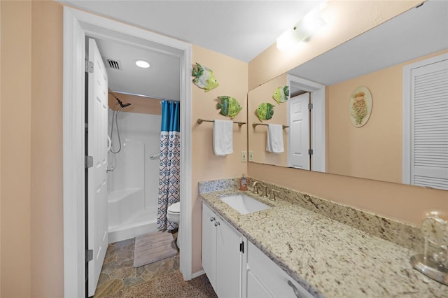 bathroom with visible vents, toilet, a stall shower, stone finish flooring, and vanity