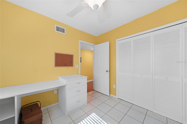 unfurnished office with a ceiling fan, visible vents, baseboards, and light tile patterned floors