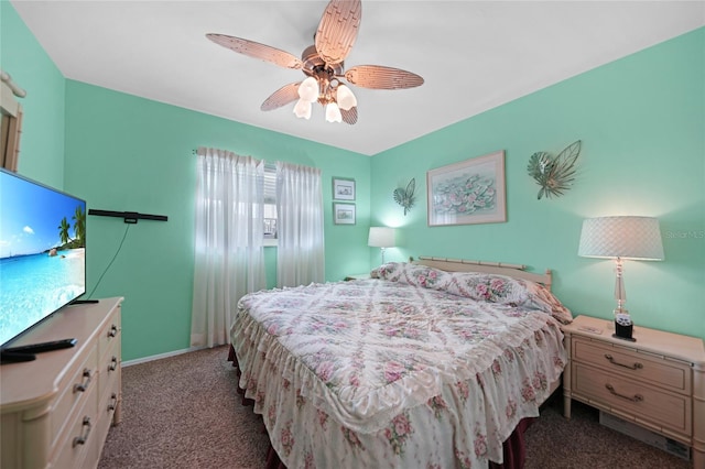 bedroom featuring dark carpet, a ceiling fan, and baseboards