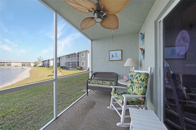 sunroom featuring a residential view and a ceiling fan