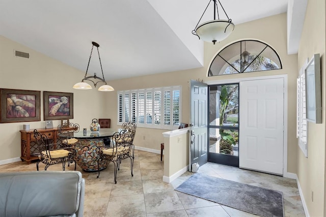 entrance foyer featuring vaulted ceiling and light tile patterned floors