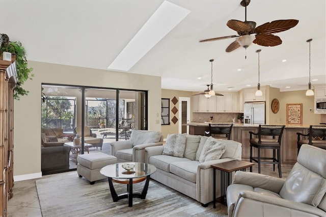 living room with ceiling fan, lofted ceiling, and light tile patterned floors