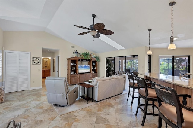 living room with lofted ceiling, sink, and ceiling fan