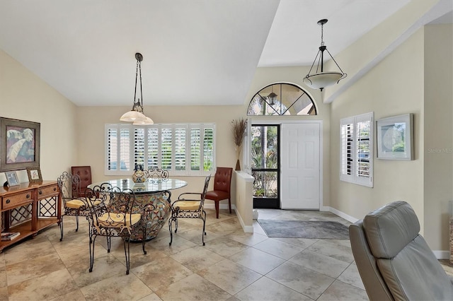 entrance foyer featuring light tile patterned flooring and high vaulted ceiling