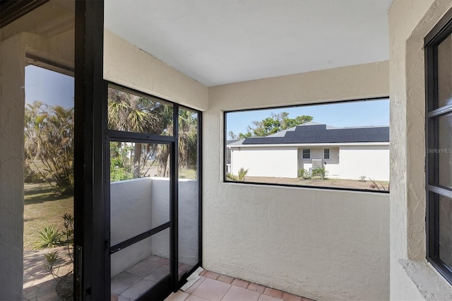 unfurnished sunroom with plenty of natural light