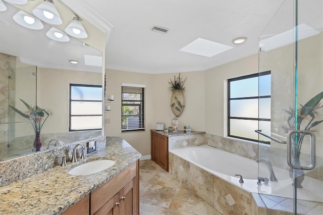 bathroom with crown molding, vanity, a skylight, and independent shower and bath