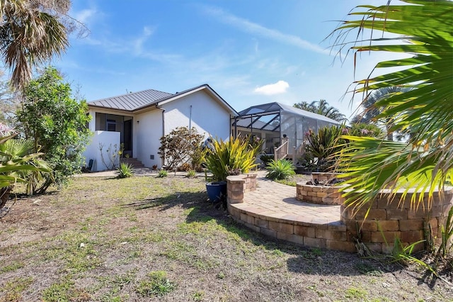 view of yard featuring a patio and a lanai