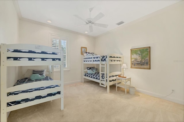 carpeted bedroom featuring crown molding and ceiling fan