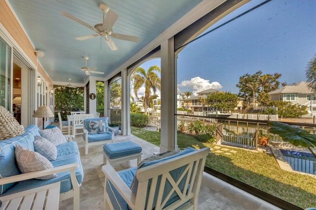 sunroom featuring ceiling fan