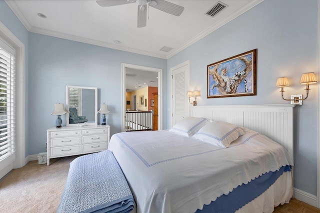 carpeted bedroom featuring ornamental molding and ceiling fan