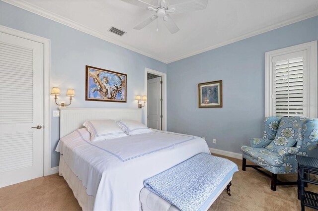 carpeted bedroom featuring crown molding and ceiling fan