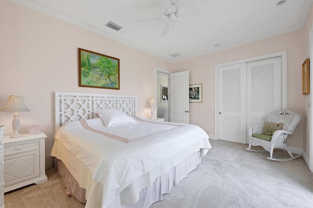 carpeted bedroom featuring crown molding, ceiling fan, and a closet