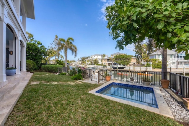 view of swimming pool featuring a water view and a lawn