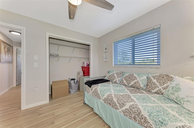 bedroom featuring ceiling fan, a closet, and light wood-type flooring