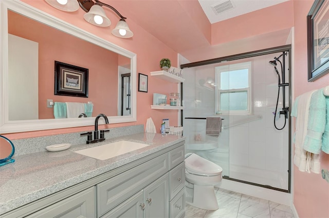 bathroom with vanity, toilet, and a shower with door