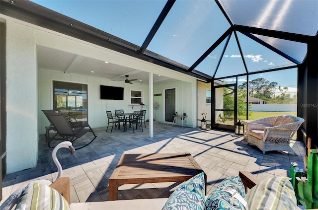 view of patio / terrace featuring outdoor lounge area, ceiling fan, and glass enclosure