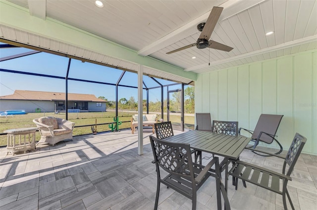 sunroom with ceiling fan, beam ceiling, and wooden ceiling