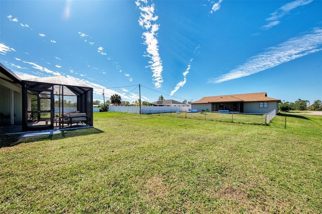 view of yard featuring glass enclosure