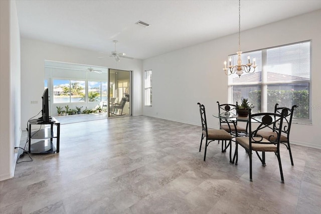 dining space with ceiling fan with notable chandelier