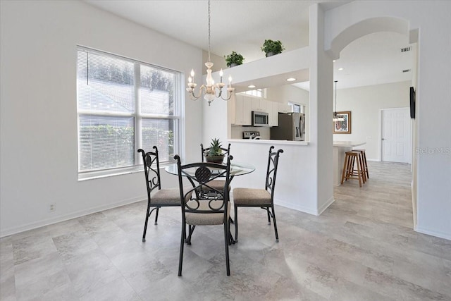 dining area featuring a notable chandelier