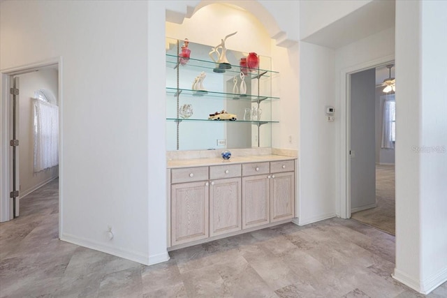 bar featuring light brown cabinetry