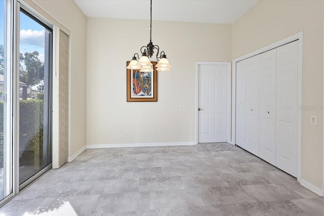 unfurnished dining area featuring an inviting chandelier