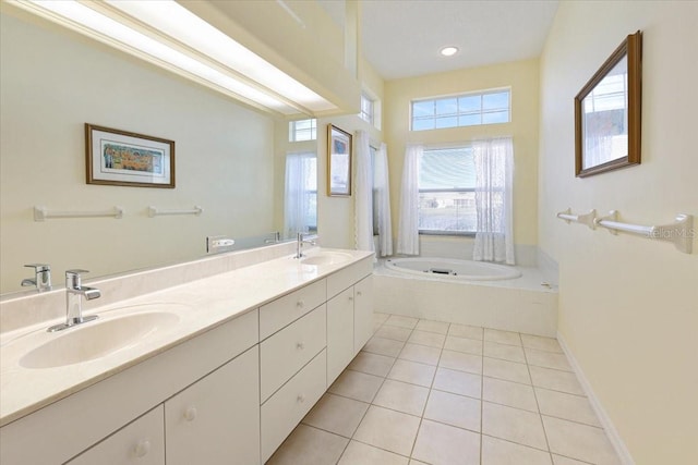 bathroom with tiled tub, vanity, and tile patterned floors