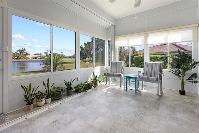 unfurnished sunroom with a water view and ceiling fan