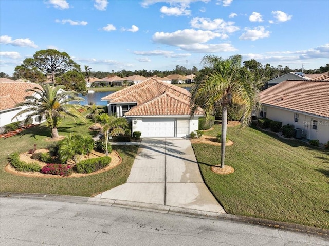 mediterranean / spanish-style home with a garage, central AC, a water view, and a front yard