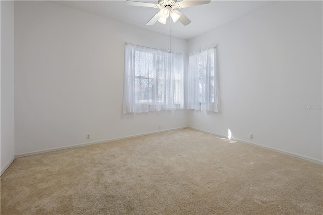 carpeted empty room featuring ceiling fan