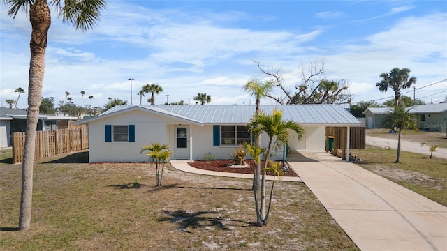 ranch-style home with a front lawn and a carport