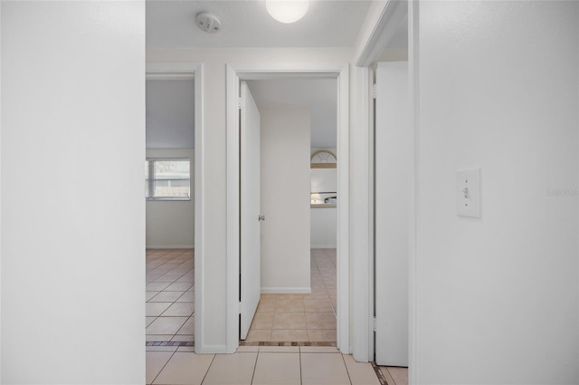 hall with light tile patterned floors