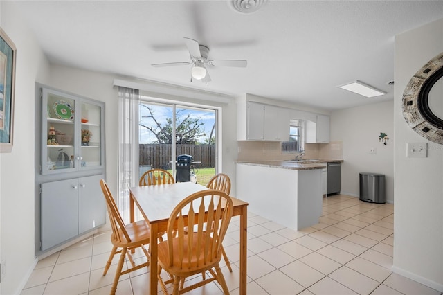 tiled dining room featuring ceiling fan