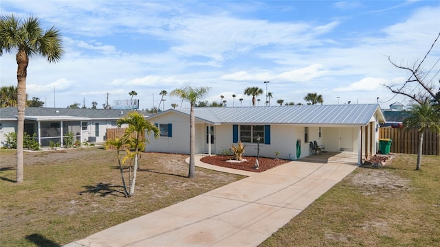 view of front of house featuring a front yard and a carport