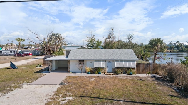 view of front of property with a carport and a water view