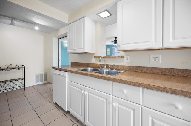 kitchen with sink, ceiling fan, white dishwasher, white cabinets, and light tile patterned flooring